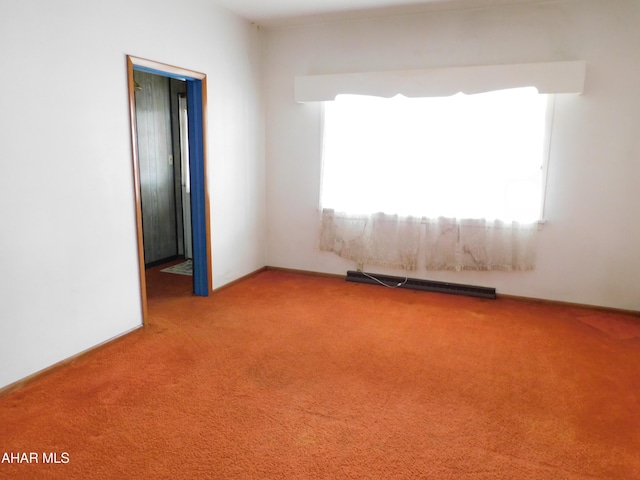 unfurnished room with a baseboard radiator and carpet flooring