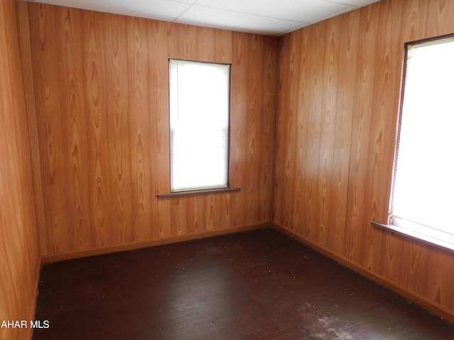 empty room with hardwood / wood-style floors and plenty of natural light