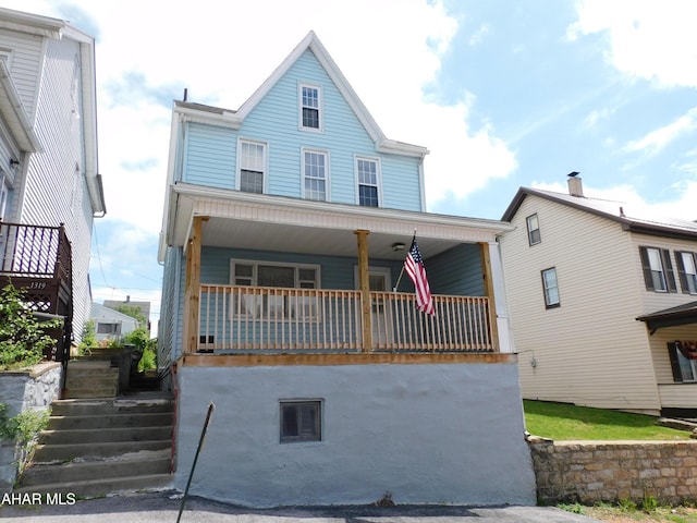 view of front of property with a porch and stairway