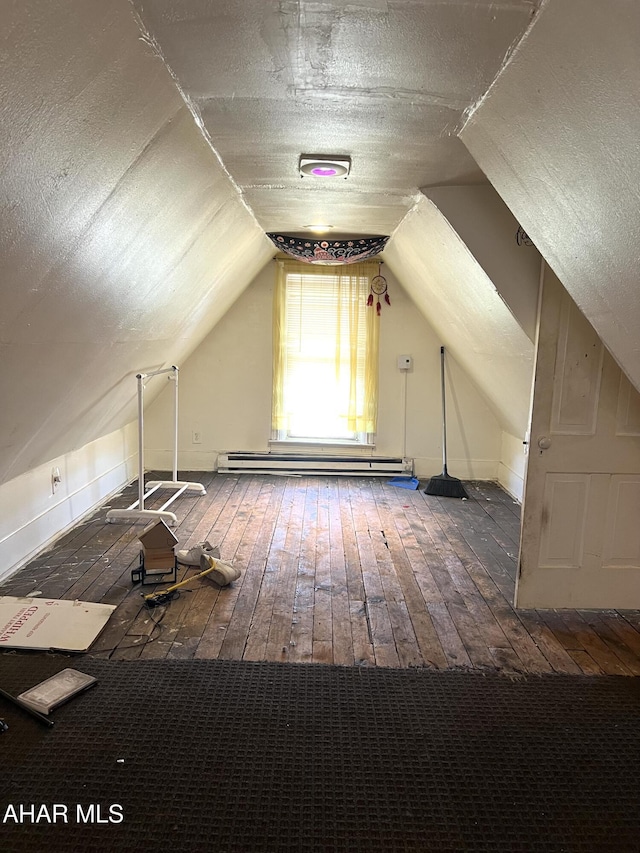 1516 3rd Ave, Altoona, PA 16602 - additional living space with a baseboard heating unit, vaulted ceiling, and wood-type flooring