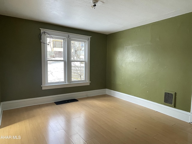 unfurnished room featuring light hardwood / wood-style flooring