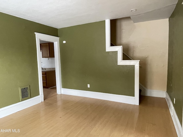 unfurnished room with wood-type flooring