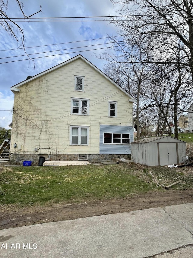 view of side of home with a storage unit and a yard