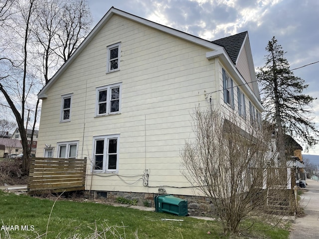 view of property exterior featuring a lawn