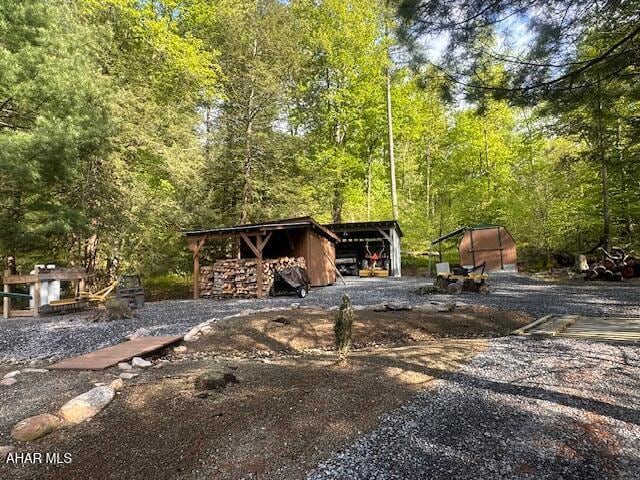 5168 Black Log Rd, Orbisonia, PA 17243 - view of yard with a view of trees, an outdoor structure, and an outbuilding