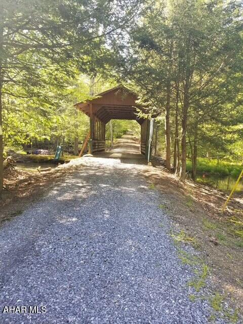 5168 Black Log Rd, Orbisonia, PA 17243 - view of vehicle parking with gravel driveway and a wooded view