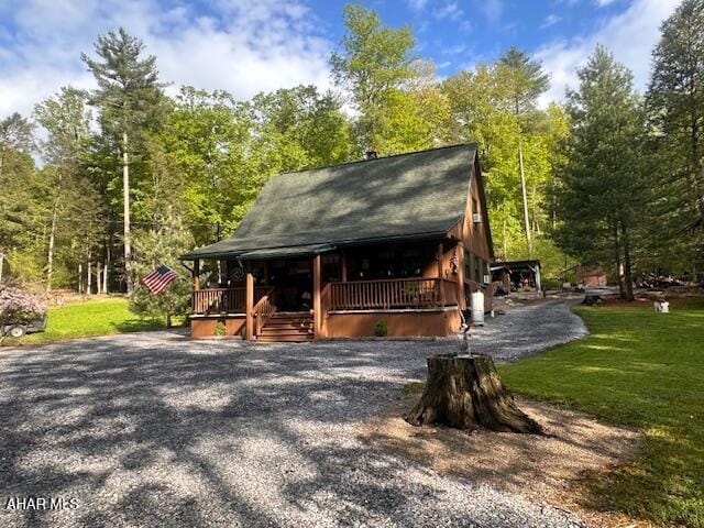 5168 Black Log Rd, Orbisonia, PA 17243 - view of front facade featuring covered porch, a front yard, and a forest view