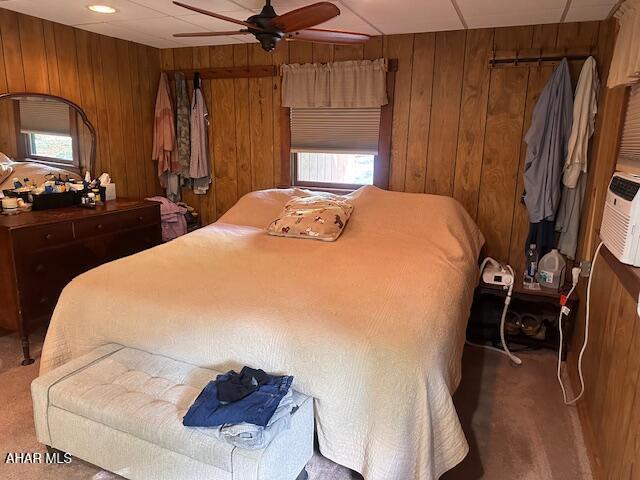 5168 Black Log Rd, Orbisonia, PA 17243 - carpeted bedroom with wooden walls, multiple windows, and ceiling fan