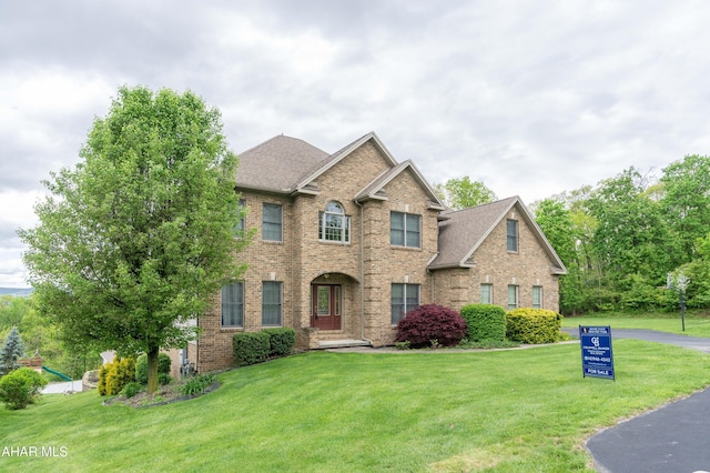 738 Chapel Dr, Altoona, PA 16602 - view of front of property featuring brick siding, a front lawn, and roof with shingles