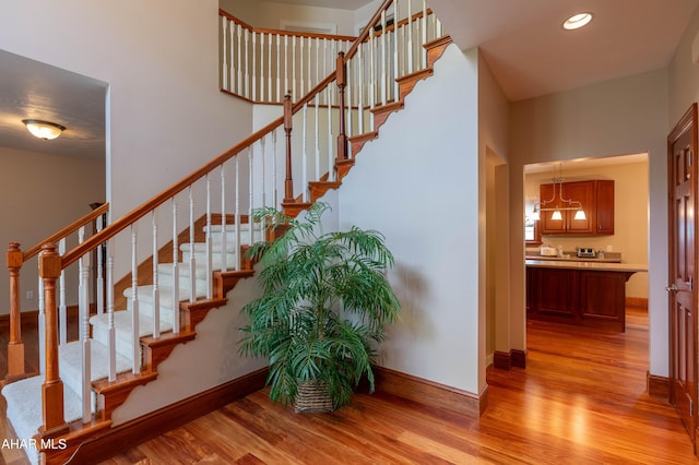 738 Chapel Dr, Altoona, PA 16602 - staircase featuring wood finished floors, baseboards, a chandelier, and recessed lighting