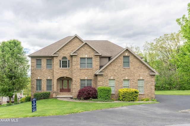 738 Chapel Dr, Altoona, PA 16602 - view of front of home with brick siding, a front lawn, and a shingled roof