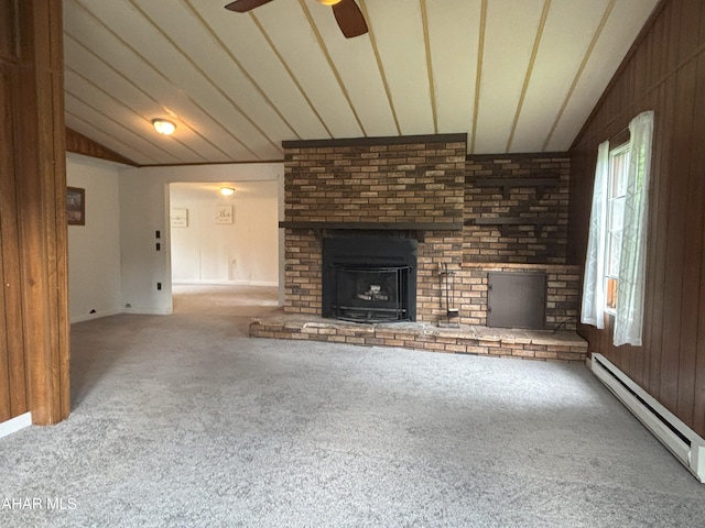 130 E 7th St, Coudersport, PA 16915 - unfurnished living room featuring a baseboard radiator, carpet floors, a brick fireplace, a ceiling fan, and lofted ceiling
