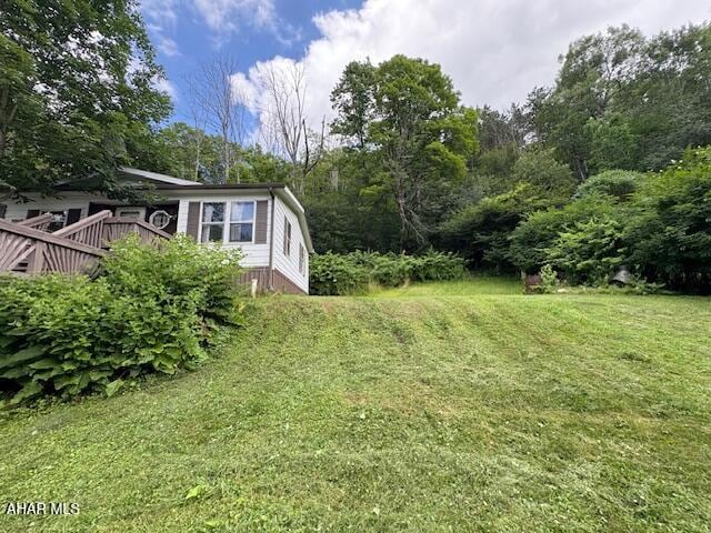 130 E 7th St, Coudersport, PA 16915 - view of grassy yard with a deck