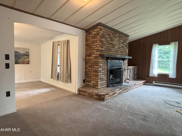 130 E 7th St, Coudersport, PA 16915 - unfurnished living room with vaulted ceiling, carpet flooring, baseboard heating, wooden walls, and a wood stove