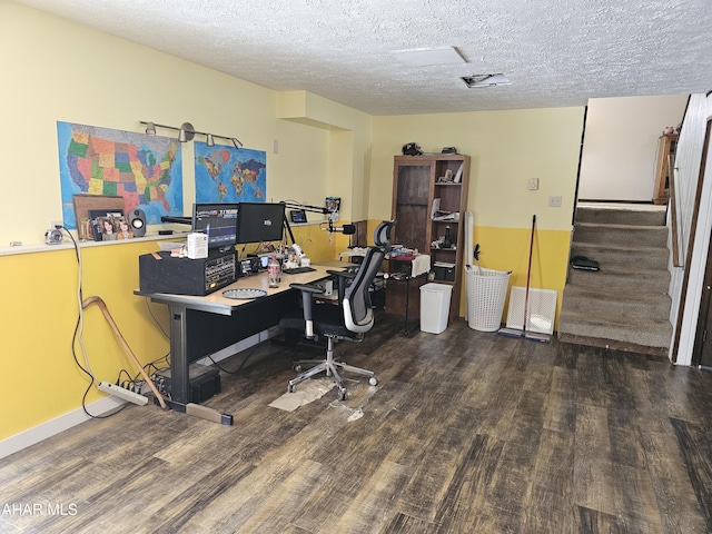 office area with dark wood-type flooring and a textured ceiling