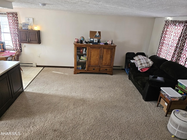 living room with baseboard heating, light colored carpet, and a textured ceiling