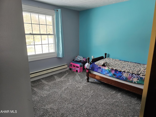 bedroom with carpet flooring, multiple windows, a textured ceiling, and a baseboard heating unit