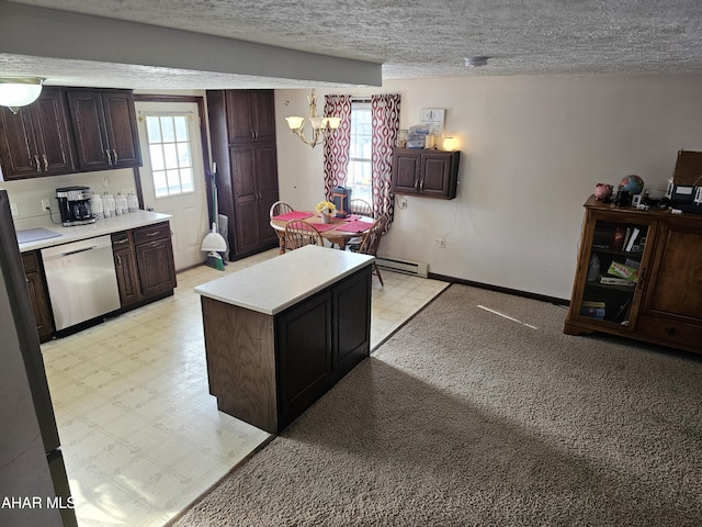 kitchen featuring a textured ceiling, an inviting chandelier, stainless steel dishwasher, and plenty of natural light