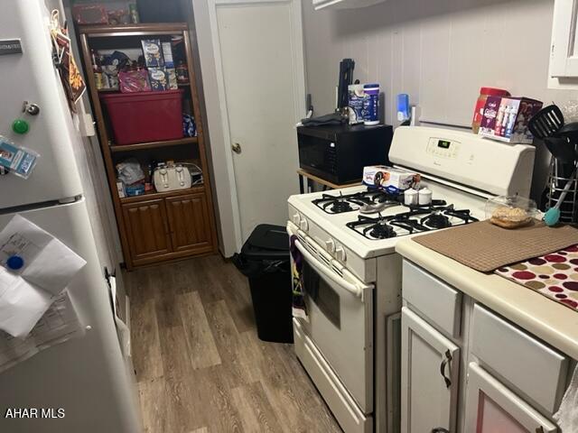1004-08 17th Ave, Altoona, PA 16601 - kitchen featuring white cabinets, fridge, white gas stove, and light hardwood / wood-style floors