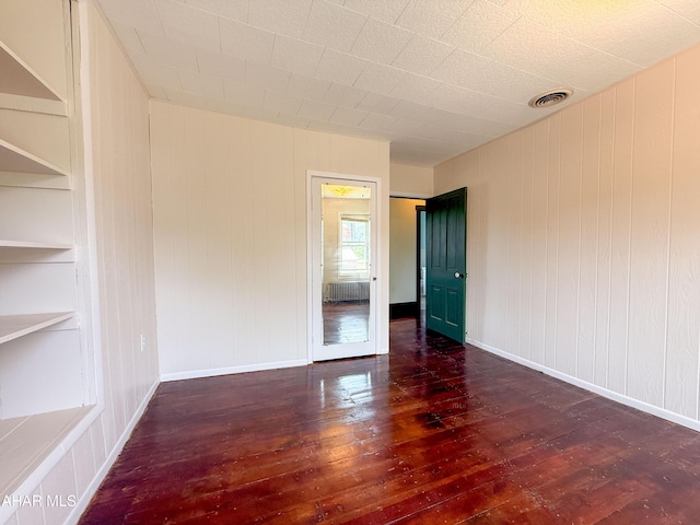 346 Lower Snake Spring Rd, Everett, PA 15537 - unfurnished room with wood-type flooring, wood walls, and built in shelves