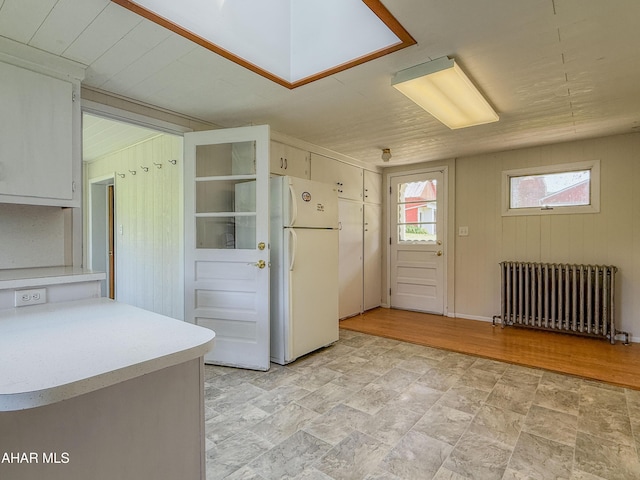 346 Lower Snake Spring Rd, Everett, PA 15537 - kitchen featuring radiator heating unit, freestanding refrigerator, light countertops, and stone finish floors