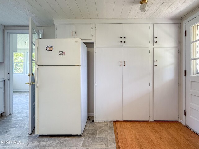 346 Lower Snake Spring Rd, Everett, PA 15537 - kitchen featuring freestanding refrigerator, wooden ceiling, white cabinetry, and light stone finish floors