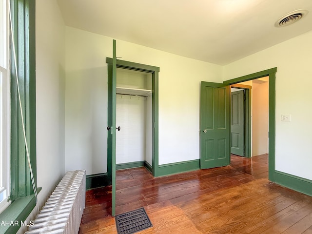 346 Lower Snake Spring Rd, Everett, PA 15537 - unfurnished bedroom featuring radiator, hardwood / wood-style floors, and a closet
