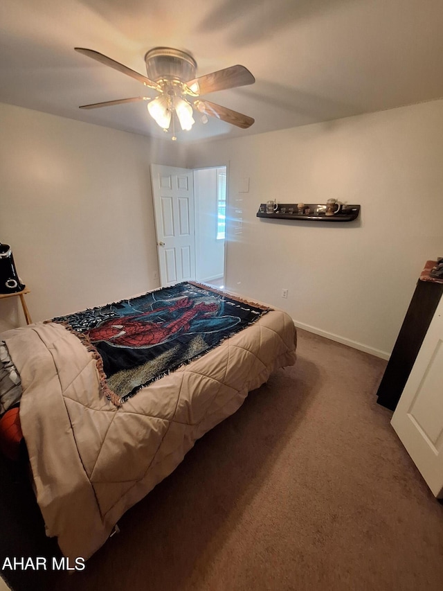 bedroom with dark carpet and ceiling fan