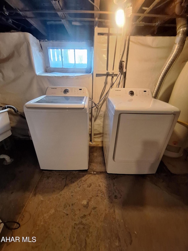 clothes washing area with washer and clothes dryer