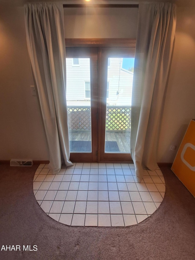 doorway with light tile patterned flooring