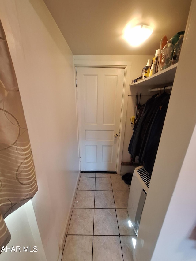 mudroom featuring light tile patterned floors and a wall unit AC