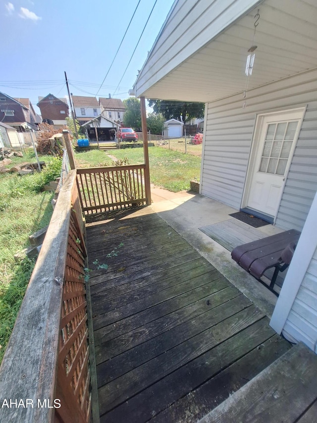 wooden deck featuring a lawn