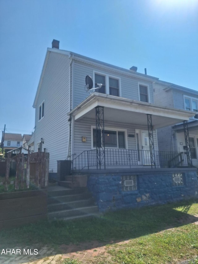 view of front of house featuring a front yard and a porch