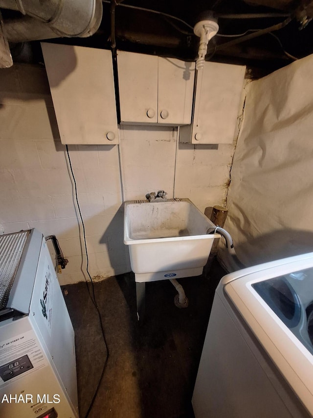 clothes washing area with sink and washer / dryer