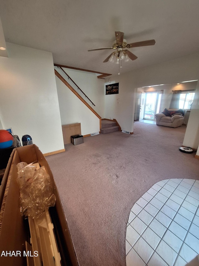 carpeted living room with ceiling fan