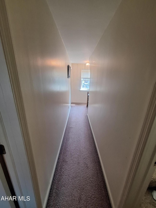 corridor featuring light colored carpet