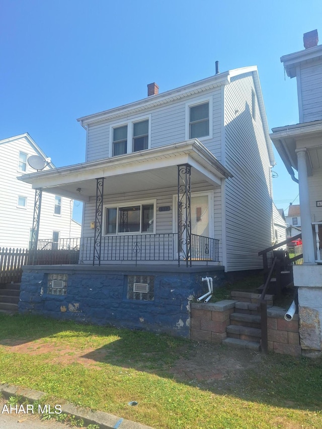 view of front of house featuring a front lawn and a porch