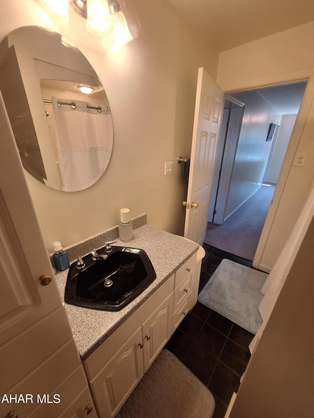 bathroom featuring tile patterned flooring and vanity