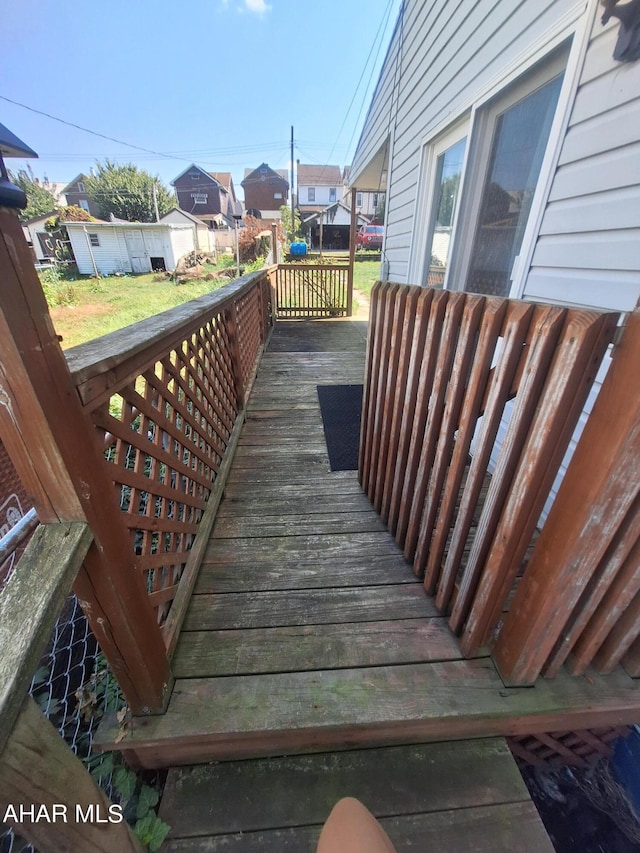 wooden terrace with a lawn