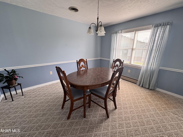 carpeted dining space featuring a baseboard heating unit, a textured ceiling, and a chandelier