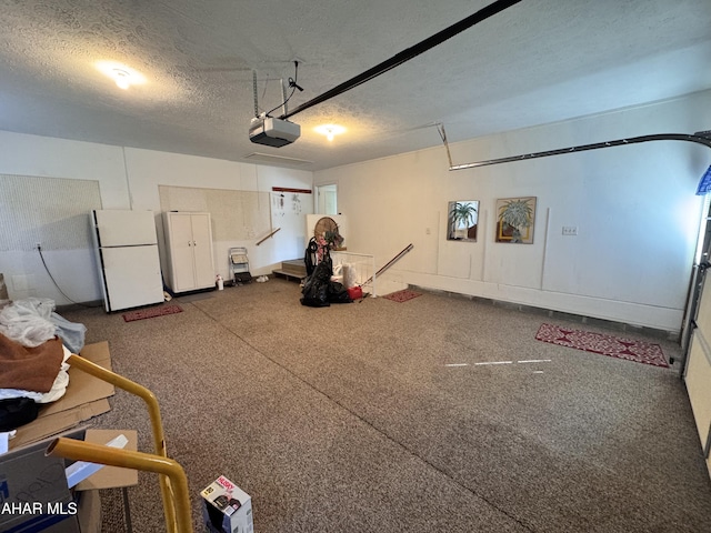 garage featuring a garage door opener and white refrigerator