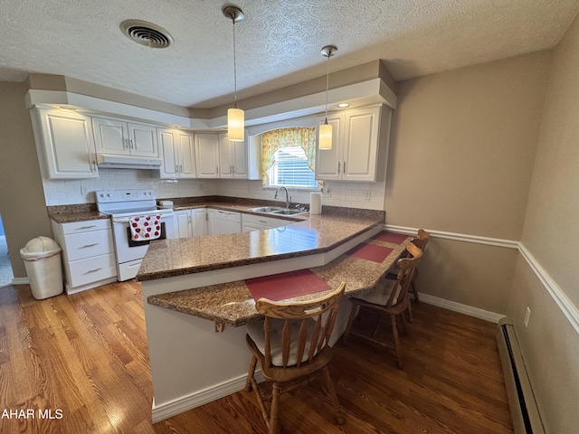 kitchen featuring baseboard heating, kitchen peninsula, white cabinets, and white electric stove