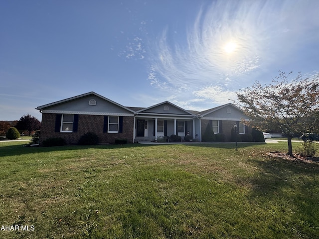 ranch-style home with covered porch and a front yard