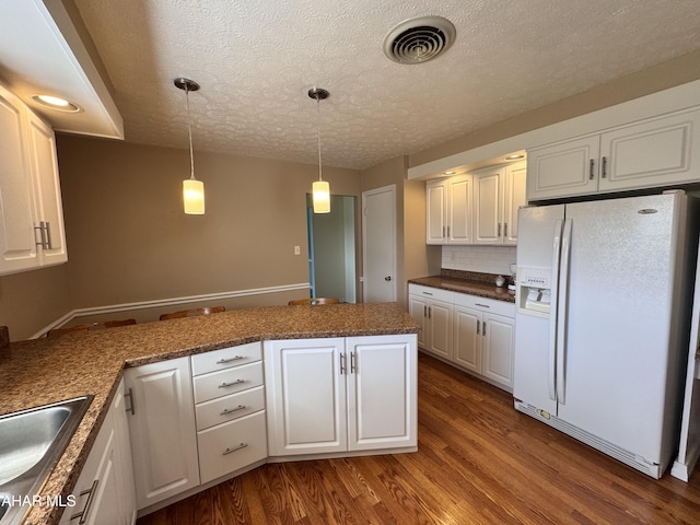 kitchen featuring pendant lighting, white cabinetry, white fridge with ice dispenser, and wood-type flooring