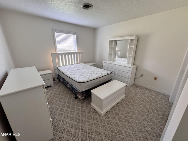 carpeted bedroom featuring a textured ceiling