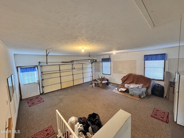 garage with white fridge and a garage door opener