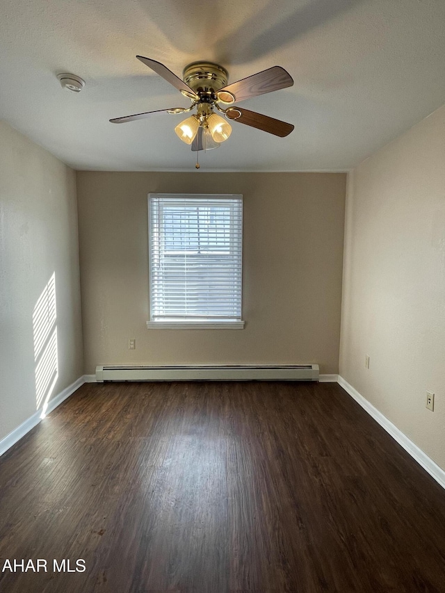 unfurnished room featuring ceiling fan, dark hardwood / wood-style floors, and baseboard heating