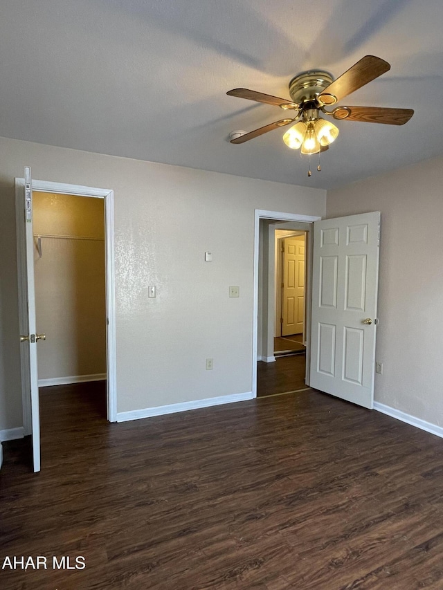 spare room featuring ceiling fan and dark wood-type flooring