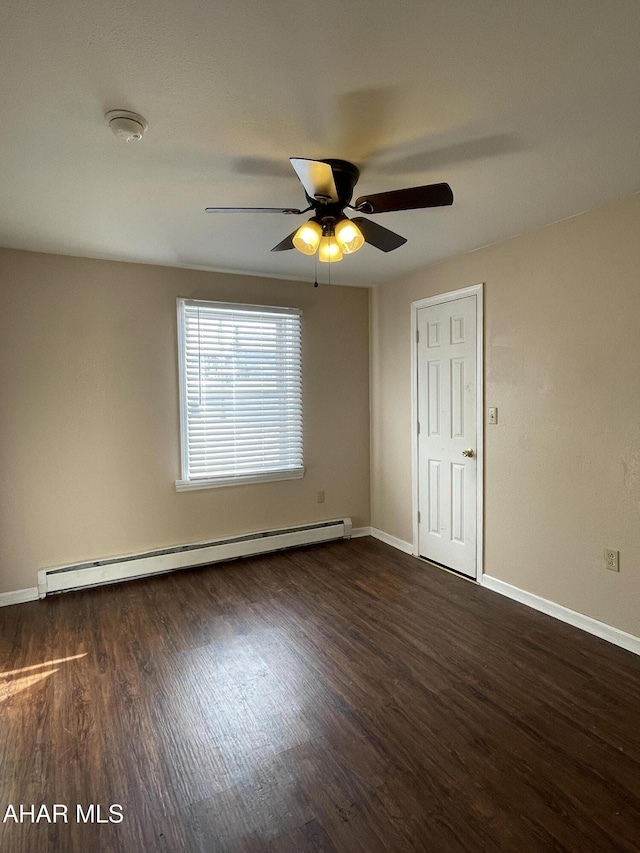 unfurnished room featuring baseboard heating, ceiling fan, and dark hardwood / wood-style flooring