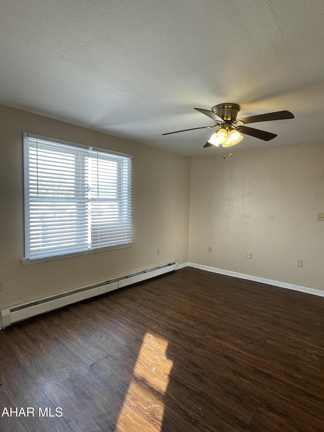 empty room featuring baseboard heating, ceiling fan, dark wood-type flooring, and a textured ceiling